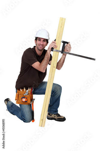 Photo: A carpenter with a plank. A carpenter with a plank.