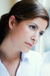Photo: young woman thinking and looking out the window young woman thinking and looking out the window