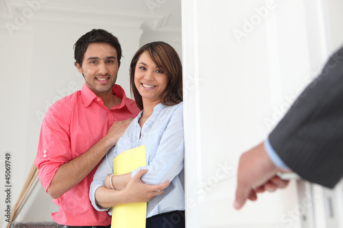 Photo: Young couple with an estate agent Young couple with an estate agent