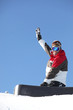 A snowboarder waving his arm