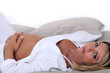 Pregnant woman laid on a bed