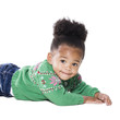 Studio portrait of baby girl (18-23 months) lying on front