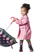 Studio portrait of baby girl (18-23 months) holding umbrella