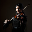 "Young woman playing violin, studio shot"