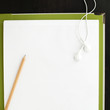 Pencil and earphones on blank paper with file