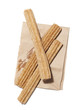 "Fresh churros on paper bag, view from above, studio shot"