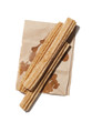 "Fresh churros on paper bag, view from above, studio shot"