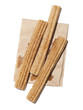 "Fresh stick shaped cakes on paper bag, view from above, studio shot"