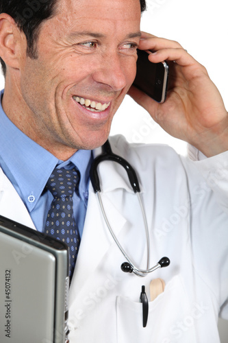 Photo: Doctor speaking on mile telephone Doctor speaking on mile telephone