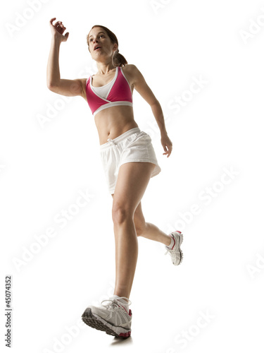 Photo: "Young woman running, on white background" "Young woman running, on white background"