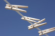 Clothes pegs hanging on washing line