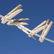 Clothes pegs hanging on washing line