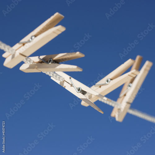 Photo: Clothes pegs hanging on washing line Clothes pegs hanging on washing line