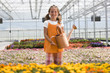 "USA, Utah, Salem, portrait of girl (8-9) in greenhouse"