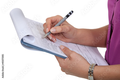 Photo: Woman filling in a form Woman filling in a form