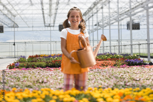 Photo: "USA, Utah, Salem, portrait of girl (8-9) in greenhouse" "USA, Utah, Salem, portrait of girl (8-9) in greenhouse"