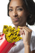 Mid adult woman holding container with mini tape measures instead of french fries