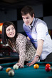 "USA, Utah, American Fork, young couple playing pool"