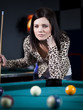 "USA, Utah, American Fork, young woman playing pool"