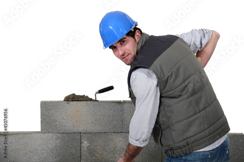Photo: A mason building a wall. A mason building a wall.