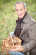 Man picking mushrooms in the forest