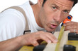 Man measuring piece wood