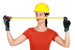 Female builder holding tape measure