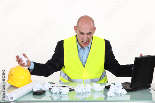 Photo: Frustrated engineer at a desk Frustrated engineer at a desk