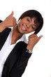 Businesswoman giving two thumbs-up to idea