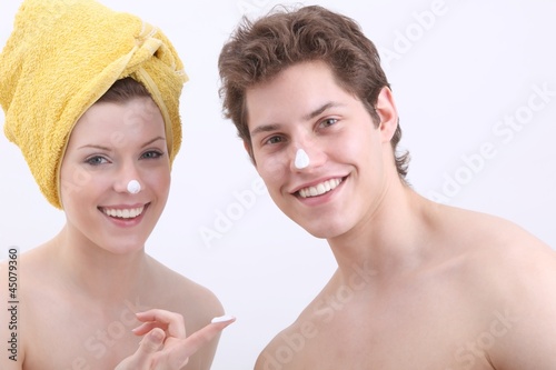 Photo: young woman and young man with lotion young woman and young man with lotion