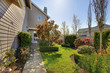 Backyard of the large beige house with walkway