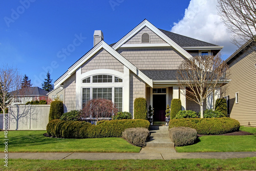 Photo: Classic new American house exterior in the spring. Classic new American house exterior in the spring.