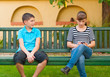 Teenage boy looking with love at indifferent teenage girl