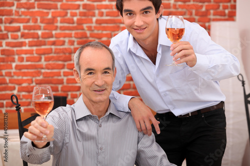 Photo: Men raising their glasses in a toast Men raising their glasses in a toast