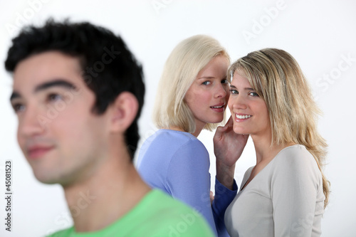 Photo: Two girls gossiping about man Two girls gossiping about man