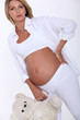 pregnant woman holding a teddy bear