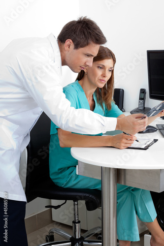 Photo: Doctor And Nurse With Dental X-Ray Report Doctor And Nurse With Dental X-Ray Report