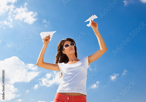 Photo: Young caucasian girl with two paper planes Young caucasian girl with two paper planes
