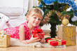 Photo: girl with gifts near a New Year tree girl with gifts near a New Year tree