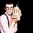 Male Nerd Inventor Holding Brick Mobile Telephone
