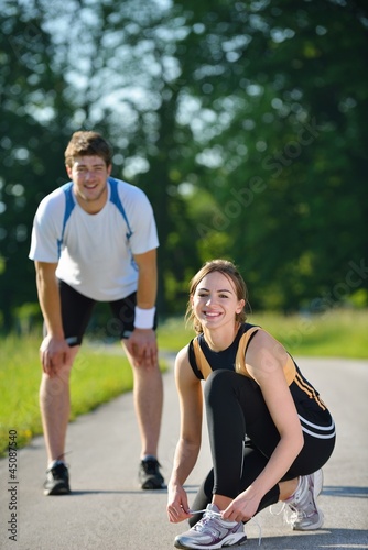 Photo: Couple doing stretching exercise after jogging Couple doing stretching exercise after jogging