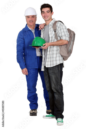 Photo: Young apprentice posing with his new boss Young apprentice posing with his new boss
