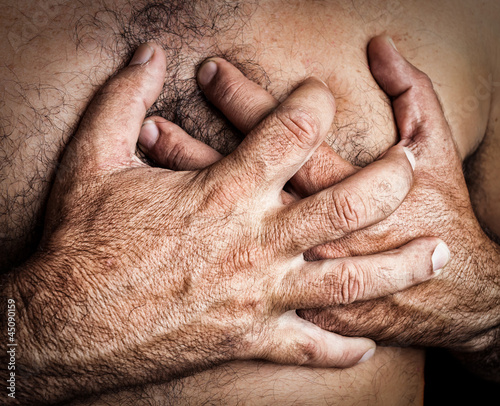 Photo: Man suffering a heart attack Man suffering a heart attack