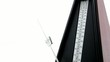 Metronome keeps time in front of white Background