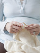 "USA, California, San Francisco, pregnant woman knitting, close-up"