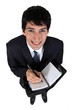 Businessman writing in a diary