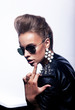 Photo: Rude woman in sunglasses indicating finger - fucking sign Rude woman in sunglasses indicating finger - fucking sign