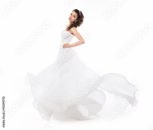 Photo: Beauty bride in wedding fashion white dress running Beauty bride in wedding fashion white dress running