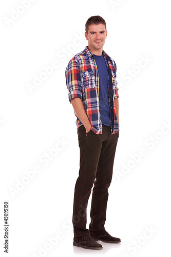 Photo: young man with hands tucked in pockets young man with hands tucked in pockets