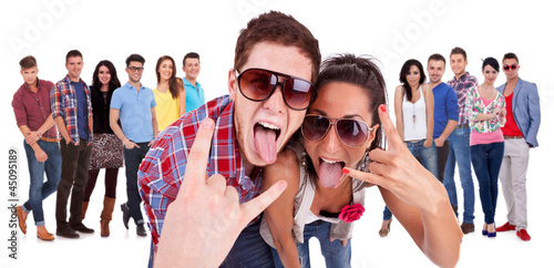 Photo: happy couple making the rock and roll gesture happy couple making the rock and roll gesture